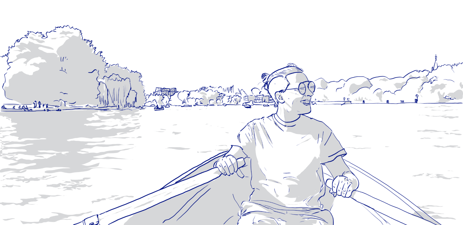 Sayan, wearing sunglasses and a t-shirt rowing a boat. Outline drawing on a bright background with grey shading. Sayan is smiling to one side, with distant trees, buildings and other boats in the background.